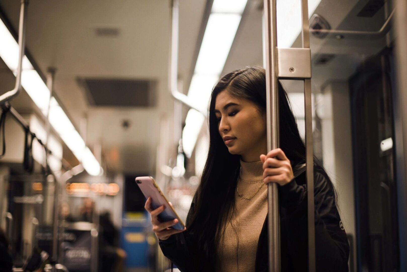 a woman checking her phone while on the train